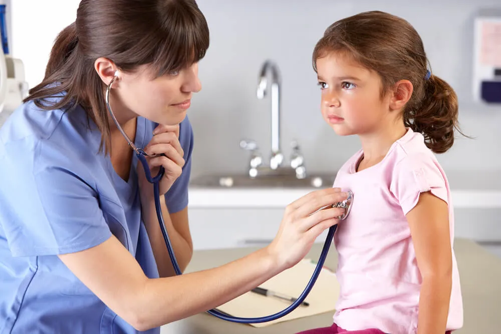 A doctor examining a young patient with a stethoscope
